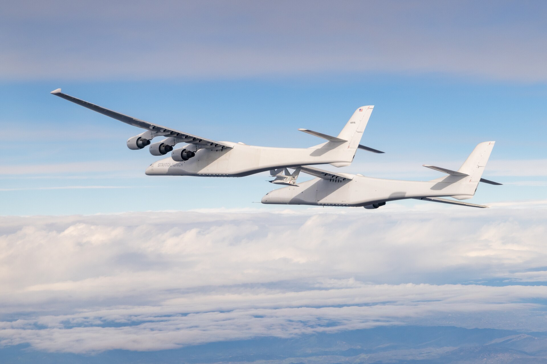 The twin-fuselage Stratolaunch Roc flying with its enormous wing spread